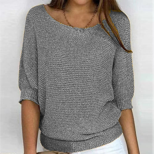 Solid color sweater with a round neckline and 3/4 sleeves