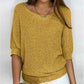 Solid color sweater with a round neckline and 3/4 sleeves